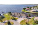 Beautiful aerial view of a waterfront home, featuring lush greenery, a circular driveway and boat dock at 12445 Krome Ave, Port Charlotte, FL 33981