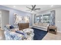 Cozy living room with stylish furniture, seahorse artwork, and large windows providing natural light at 13348 Boabadilla Ln, Port Charlotte, FL 33981