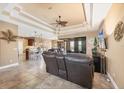 Open-concept living area with tile flooring, a decorative ceiling, and access to the lanai at 15092 Chinook Way, Port Charlotte, FL 33981