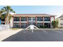 Inviting condo building featuring brick accents, screened balconies, and convenient parking at 1531 Placida Rd # 4-103, Englewood, FL 34223