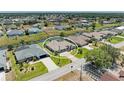 Aerial view of home featuring backyard canal access and a well maintained lawn at 169 Fairway Rd, Rotonda West, FL 33947