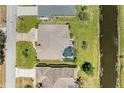 An aerial view of the residence highlighting the screened lanai and pool, with backyard canal access at 169 Fairway Rd, Rotonda West, FL 33947
