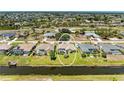 An aerial view of the property showcases its canal-front location in a residential neighborhood at 169 Fairway Rd, Rotonda West, FL 33947