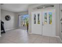 Inviting foyer showcasing tile floors, natural light, and a view into other living spaces at 1962 Remus Ave, North Port, FL 34286