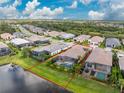 Aerial view of property outlined in red, with pool, lake, and neighborhood at 257 Corelli Dr, Nokomis, FL 34275