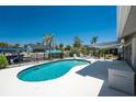 Private pool surrounded by a spacious patio and black metal fence, perfect for outdoor relaxation and entertainment at 2673 Titania Rd, Englewood, FL 34224
