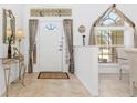 Bright foyer featuring tile flooring and a decorative window above the front door at 39 Medalist Ln, Rotonda West, FL 33947