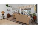 Cozy living room with neutral tones, plush seating, and view of the lanai at 39 Medalist Ln, Rotonda West, FL 33947