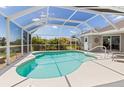 Relaxing screened-in pool with clear blue water and plenty of space for lounging at 39 Medalist Ln, Rotonda West, FL 33947