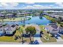 Captivating aerial view of the property, highlighting its proximity to a beautiful lake at 4115 Hemingway Dr, Venice, FL 34293