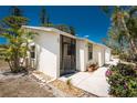 Inviting single-story villa featuring a screened entrance, landscaped front, and sunny curb appeal at 6796 Gasparilla Pines Blvd # 63, Englewood, FL 34224