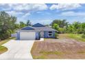 Charming single-Gathering home with an attached garage, lush landscaping, and a well-maintained lawn at 7332 Brandywine Dr, Englewood, FL 34224