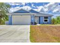 Charming single-Gathering home with an attached garage, lush landscaping, and a well-maintained lawn at 7332 Brandywine Dr, Englewood, FL 34224