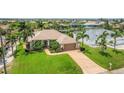 An aerial perspective showcasing a home with lush landscaping and a waterway behind the property at 8180 Burwell Cir, Port Charlotte, FL 33981