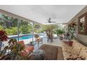 Inviting sun room leading to a refreshing pool and lush landscaping, perfect for relaxation and entertainment at 875 Morrison Ave, Englewood, FL 34223