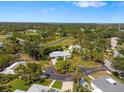 Aerial view of the home nestled among lush greenery and mature trees in a peaceful neighborhood at 1 Curacao Cir # 44, Englewood, FL 34223