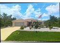 Inviting single-Gathering home boasting mature landscaping, a driveway, and an American flag on a well-manicured lawn at 10064 Cocoa Beach St, Port Charlotte, FL 33981