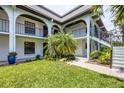 Charming condo courtyard with lush green lawn and mature tropical landscaping at 149 Englewood Isles Pkwy # 603, Englewood, FL 34223