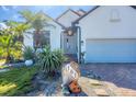 Close up of home featuring landscaped yard and charming rock with the home's address at 161 Haddock Dr, Rotonda West, FL 33947