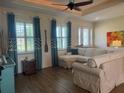 Bright living room with tray ceiling, wood floors, plenty of windows and comfortable seating at 174 Broadmoor Ln, Rotonda West, FL 33947