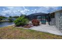 Landscaped backyard with an enclosed pool and convenient access to the canal at 18451 Goodman Cir, Port Charlotte, FL 33948