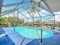 This screened pool offers privacy and relaxation with picturesque views of the surrounding canal at 18790 Countryman Ave, Port Charlotte, FL 33948