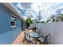 Cozy outdoor patio with a glass table and chairs, perfect for relaxation and outdoor dining at 1965 Louisiana Ave, Englewood, FL 34224