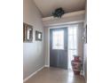 Inviting entryway featuring tile floors, a decorative mirror, a large vase, and a transom window at 2125 Floribanna St, North Port, FL 34287