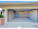 Spacious two car garage with neutral paint, lighting, and epoxy flooring at 237 Rotonda E Blvd, Rotonda West, FL 33947