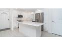 Bright kitchen featuring an island, stainless steel appliances, and white cabinetry at 2700 N Beach Rd # A201, Englewood, FL 34223