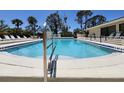 Community pool with in-water steps and several lounge chairs surrounding pool at 4260 Placida Rd # 21C, Englewood, FL 34224