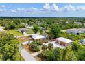 Wide aerial shot of a single-Gathering home and detached garage with a spacious backyard and beautiful landscaping at 5250 Callaway St, Port Charlotte, FL 33981
