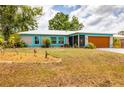 Charming single-Gathering home features a well-manicured lawn with xeriscape landscaping and attached garage at 5250 Callaway St, Port Charlotte, FL 33981