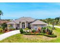 Well-manicured landscaping of this single story home with manicured lawn at 585 Coral Creek Dr, Placida, FL 33946