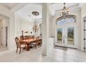 Inviting foyer with tiled floor, chandelier, high ceiling and an adjacent dining area at 585 Coral Creek Dr, Placida, FL 33946