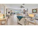 Bright and spacious living room with tile floors, ceiling fans, and sliding doors leading to an outdoor area at 5879 Venisota Rd, Venice, FL 34293