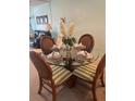 The dining area features a glass table with seating for four and decorative place settings at 708 Tamiami S Trl # 216, Venice, FL 34285