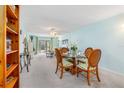 Cozy dining room featuring a round glass table with seating for four, carpeted floors, and bright paint at 708 Tamiami S Trl # 216, Venice, FL 34285