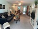 Comfortable living room with tile flooring, stylish furnishings, and lots of living space at 708 Tamiami S Trl # 216, Venice, FL 34285