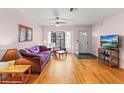 Cozy living room featuring hardwood floors, comfortable furniture, and natural light at 7180 Quarry St, Englewood, FL 34224