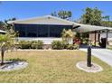 Charming single-story home featuring a covered parking area and meticulously maintained landscaping at 786 Heathercreek Ct, Englewood, FL 34223