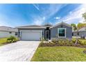 Charming single-story home featuring a paved driveway, well-manicured lawn, and a two car garage at 8244 Shore Lake Dr, Englewood, FL 34224