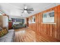 Spacious living area with hardwood floors, wood paneled walls and comfortable seating at 857 Palmetto St, Englewood, FL 34223
