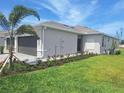 Side view of this lovely home with well-manicured lawn and landscaping at 8661 Seasalt Loop, Englewood, FL 34224