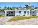 A well-maintained home with a carport attached and well-kept lawn with a concrete driveway at 868 Harvard St, Englewood, FL 34223