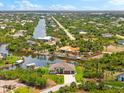 Aerial view of single Gathering home with a private dock, surrounded by canals and lush landscaping at 9470 Wacker Ter, Port Charlotte, FL 33981