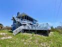 Inviting screened-in porch and an expansive white wooden deck perfect for outdoor entertaining and relaxation at 9594 Doubloon Trl, Placida, FL 33946