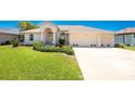 Charming single-story home with a three-car garage and well-manicured lawn at 1157 Rotonda Cir, Rotonda West, FL 33947