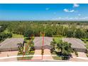 Expansive home in a lush community with manicured landscaping and views of a golf course at 13392 Abercrombie Dr, Englewood, FL 34223
