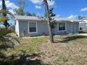 Well-maintained single-story home with a tidy front lawn and neutral-toned exterior at 13561 Darnell Ave, Port Charlotte, FL 33981